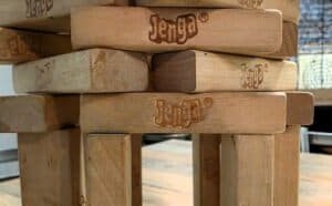 Jenga is a game about removing blocks while avoiding the tower from falling. Or build it into a cool-looking tower at Dungeon Throwers in Madison.